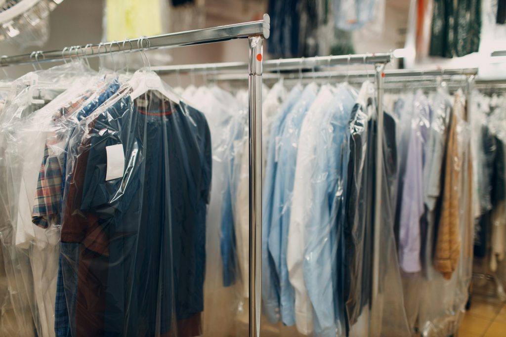 Dry cleaning clothes. Clean cloth chemical process. Laundry industrial dry-cleaning